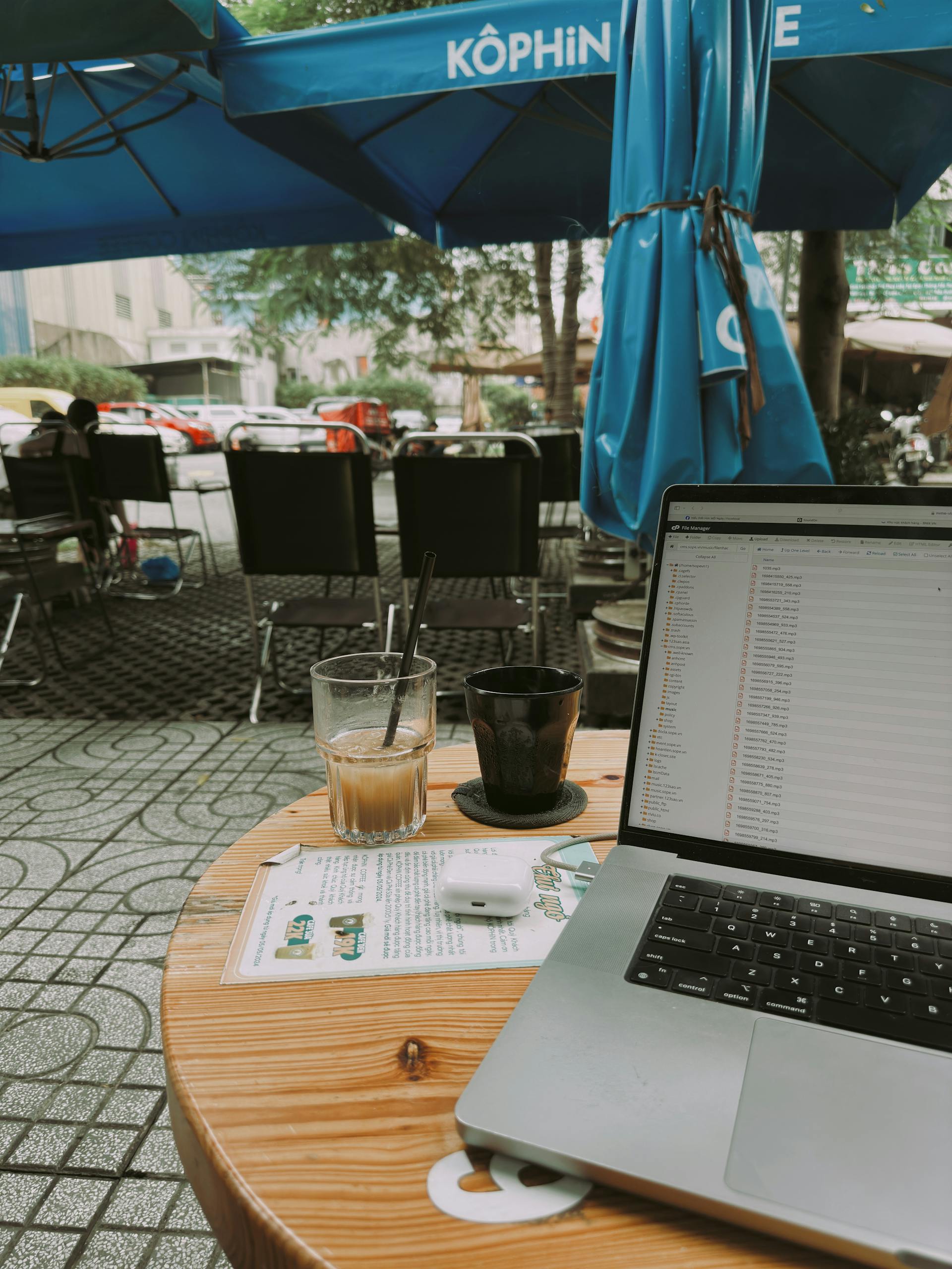Outdoor cafe with laptop and coffee, perfect for remote work inspiration.